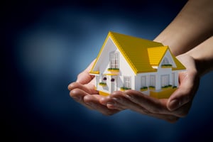 human holding small house mortgage refinance